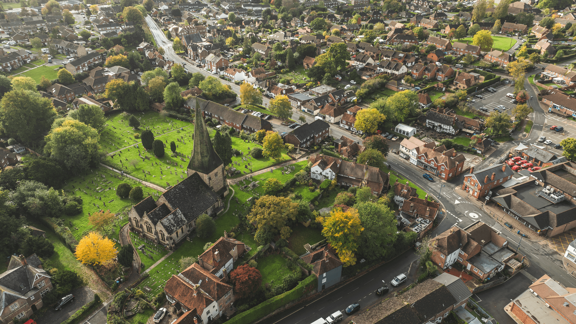 Aerial view of an English village showing the church, high street and surrounding houses